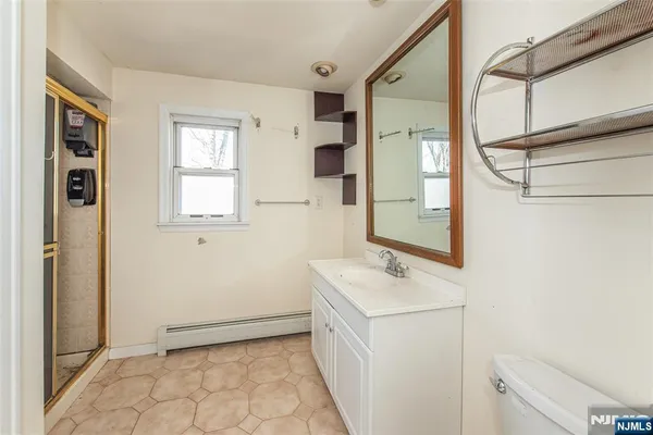 a bathroom with a sink a toilet and a mirror