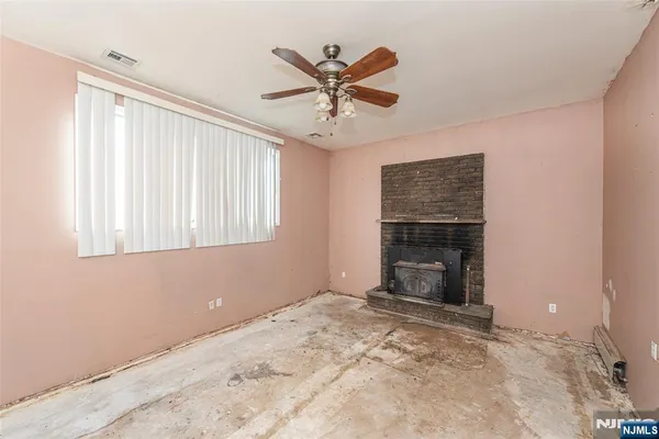 a view of a livingroom with a ceiling fan and window