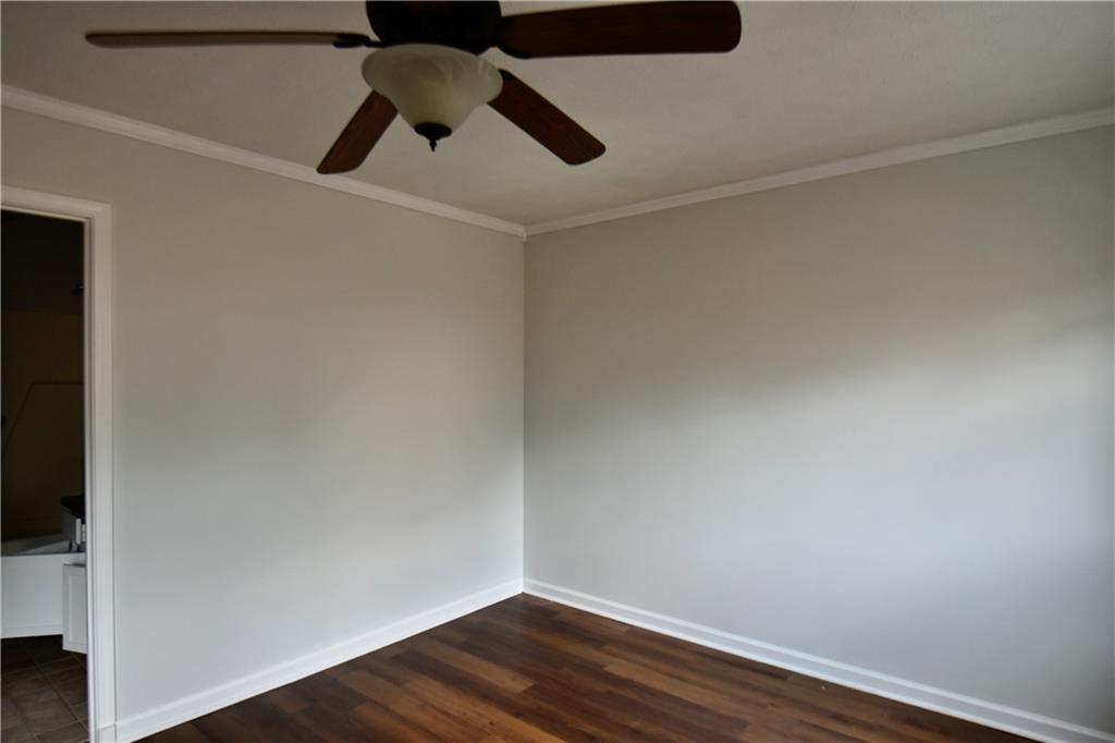 2898 Webb Bridge Road Alpharetta, GA 30009 - Photo 6 of 8 a view of an empty room with wooden floor