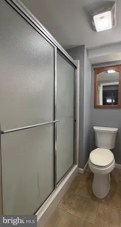 a bathroom with a toilet and a shower