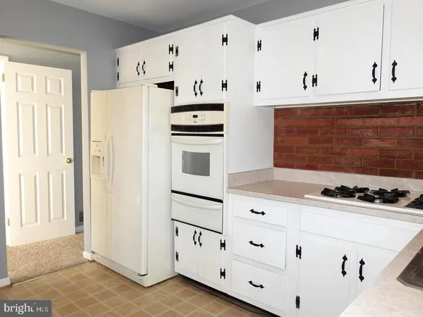 a white refrigerator freezer sitting inside of a kitchen