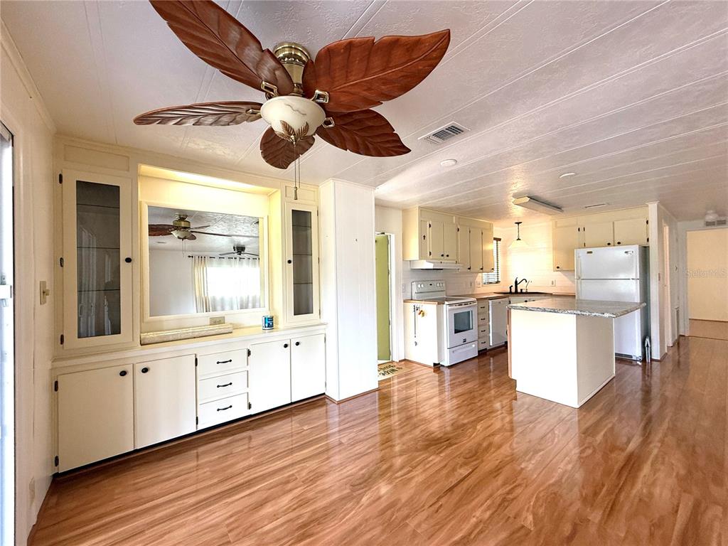 210 North St Thomas Circle Apollo Beach, FL 33572 - Photo 11 of 34 a large kitchen with cabinets wooden floor and stainless steel appliances