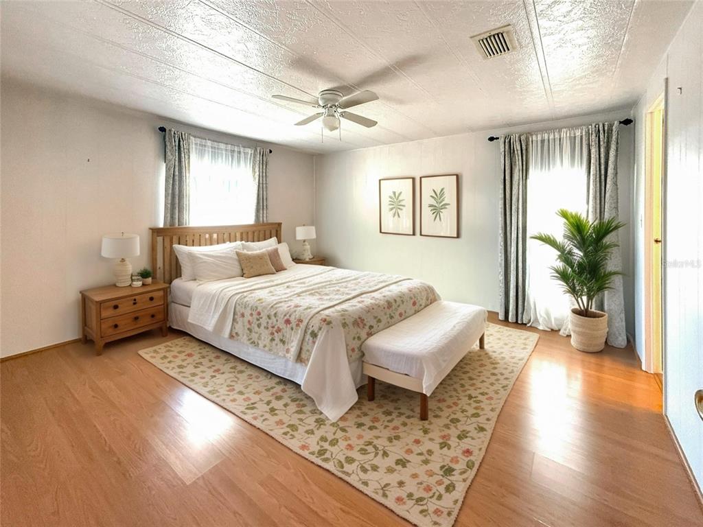 210 North St Thomas Circle Apollo Beach, FL 33572 - Photo 14 of 34 a bedroom with a large bed and a couch