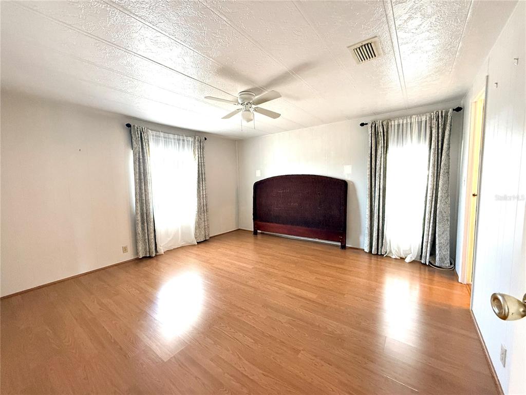 210 North St Thomas Circle Apollo Beach, FL 33572 - Photo 15 of 34 a view of an empty room with wooden floor and a window