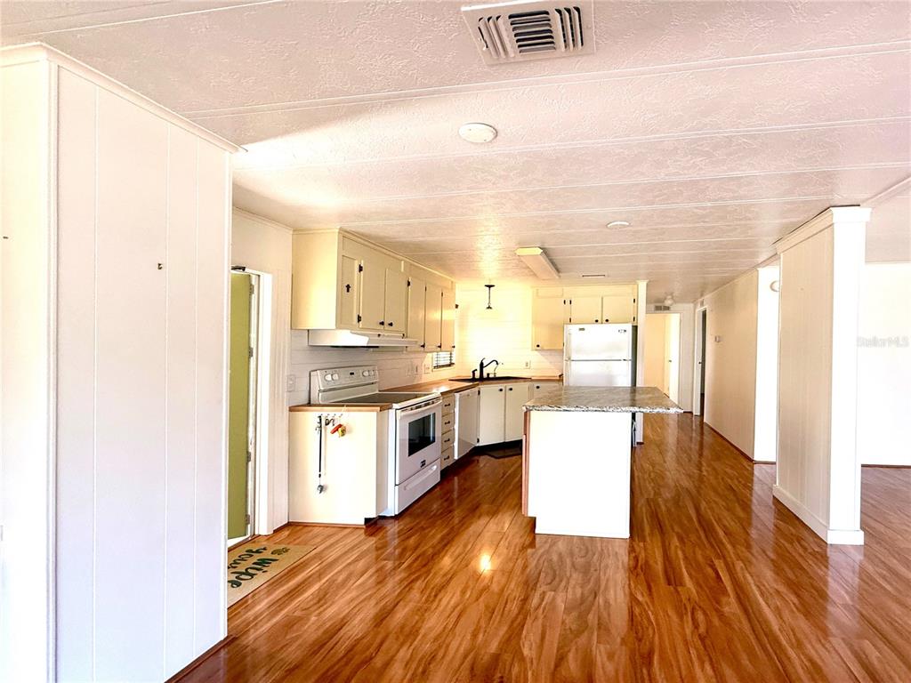 210 North St Thomas Circle Apollo Beach, FL 33572 - Photo 4 of 34 a large kitchen with a lot of counter space and wooden floor