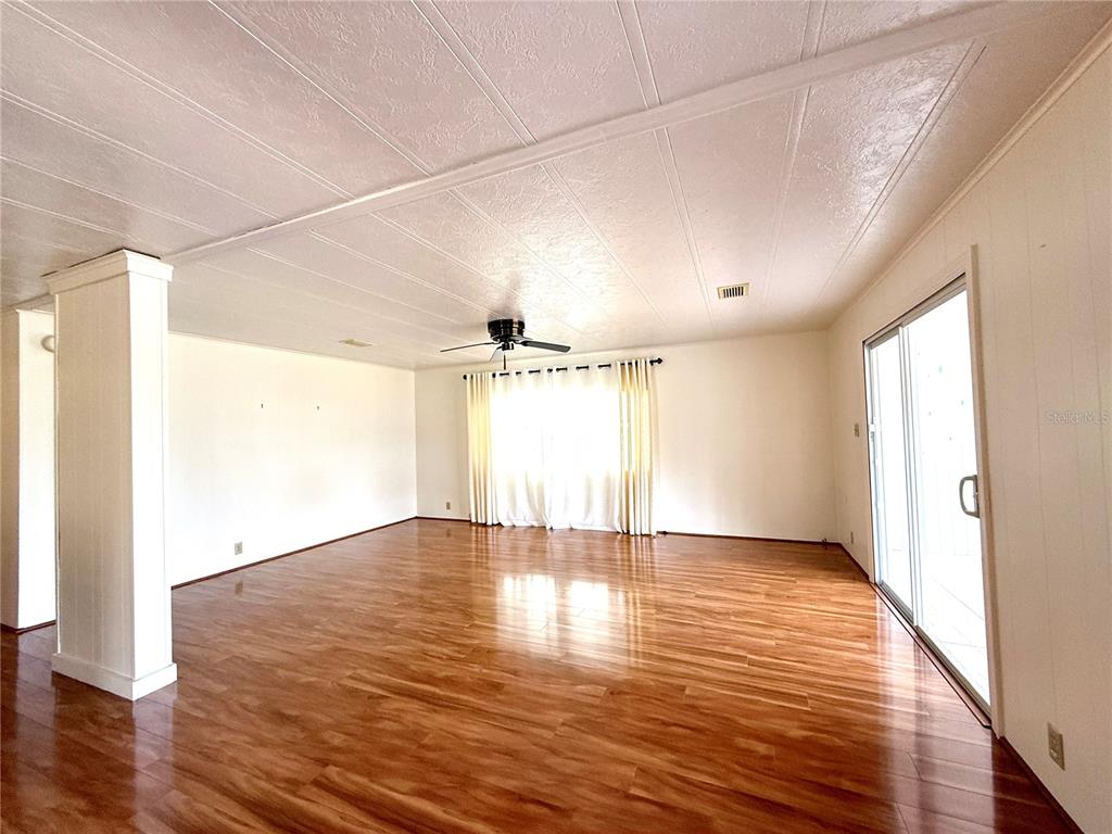 210 North St Thomas Circle Apollo Beach, FL 33572 - Photo 6 of 34 a view of an empty room with wooden floor and a window