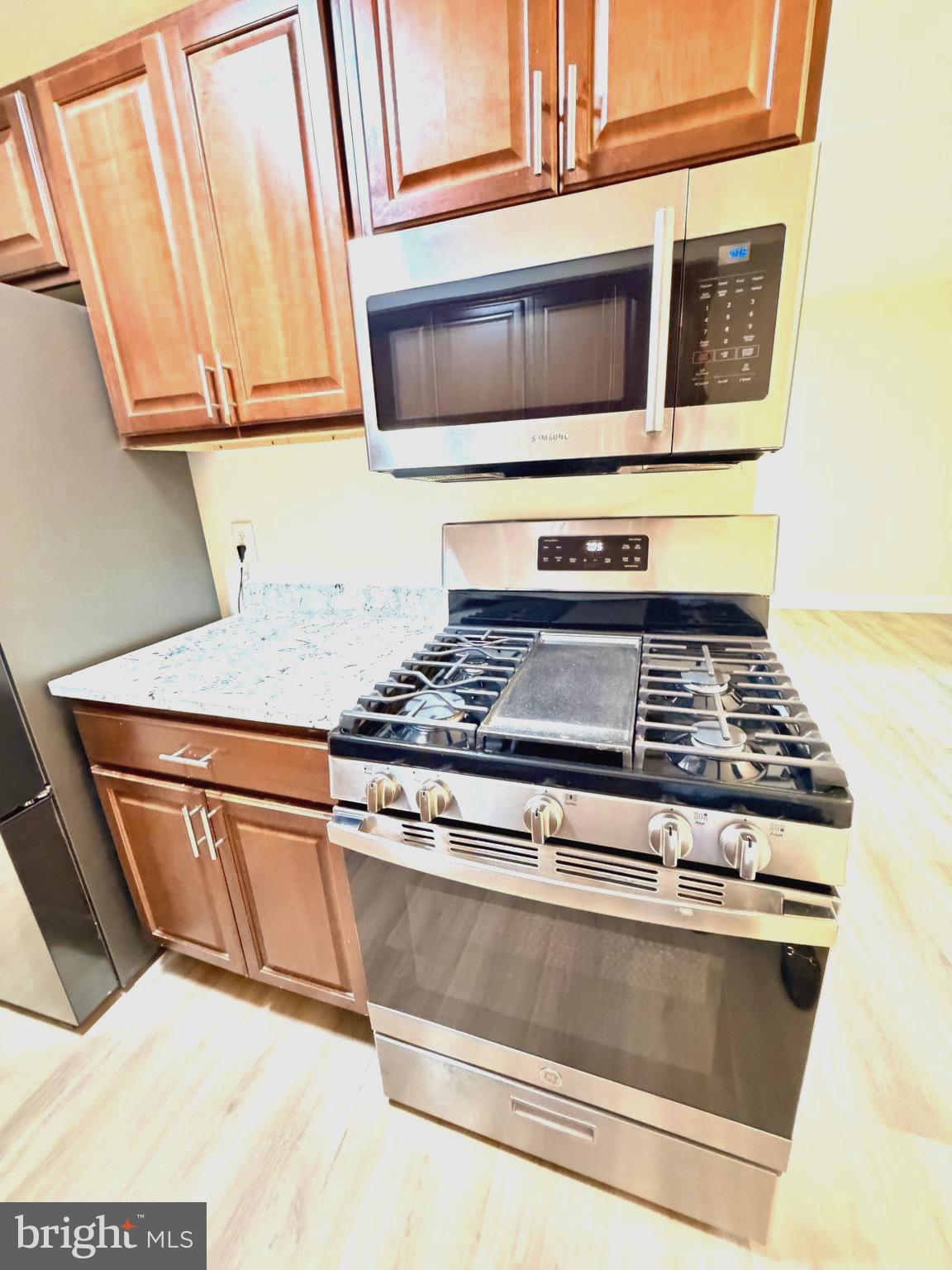 2316 Freetown Court, Unit 1B Reston, VA 20191 - Photo 7 of 36 a kitchen with granite countertop cabinets and steel stainless steel appliances