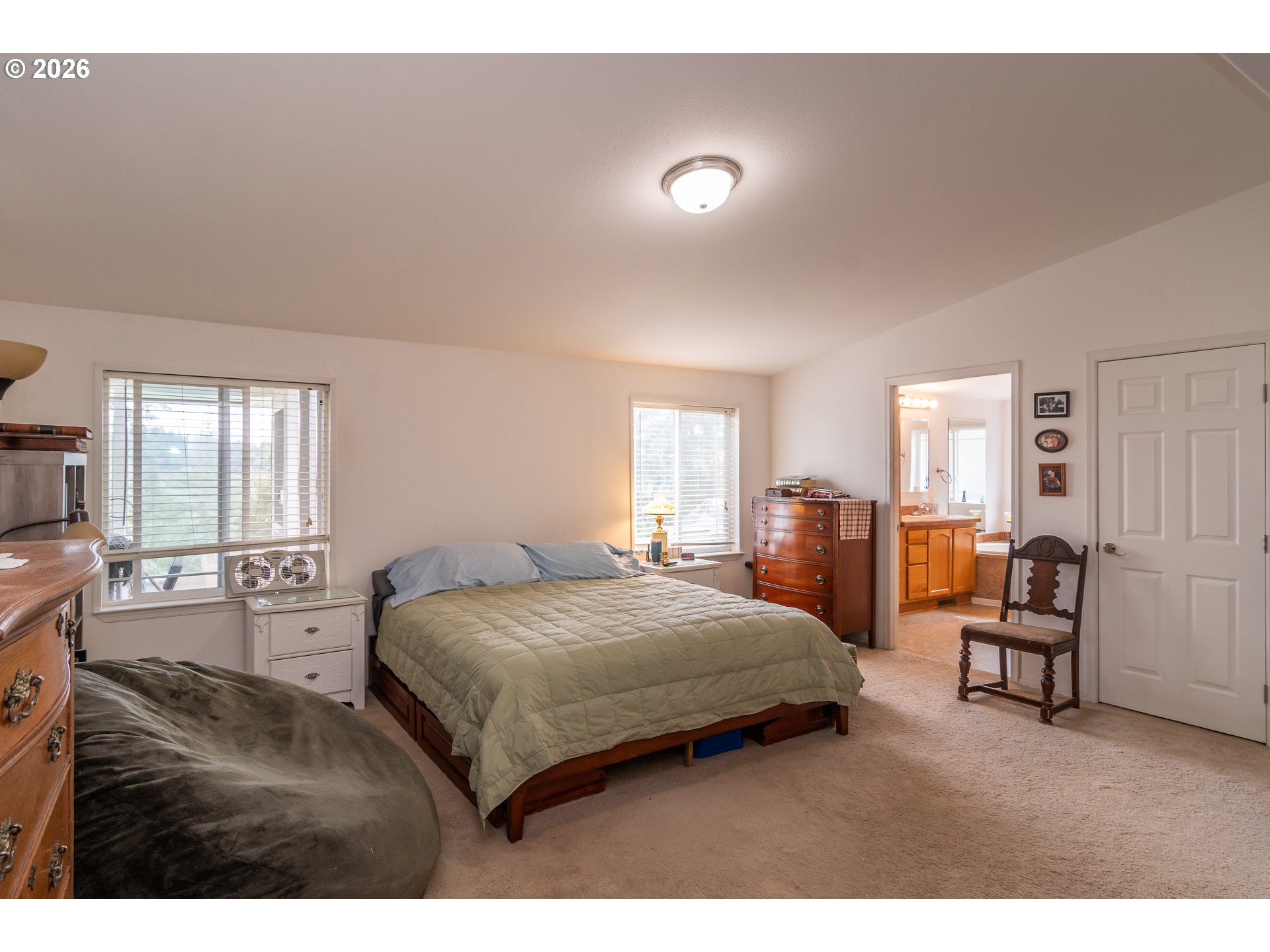 562 Valley Road Roseburg, OR 97471 - Photo 21 of 48 a bedroom with a bed and wooden floor