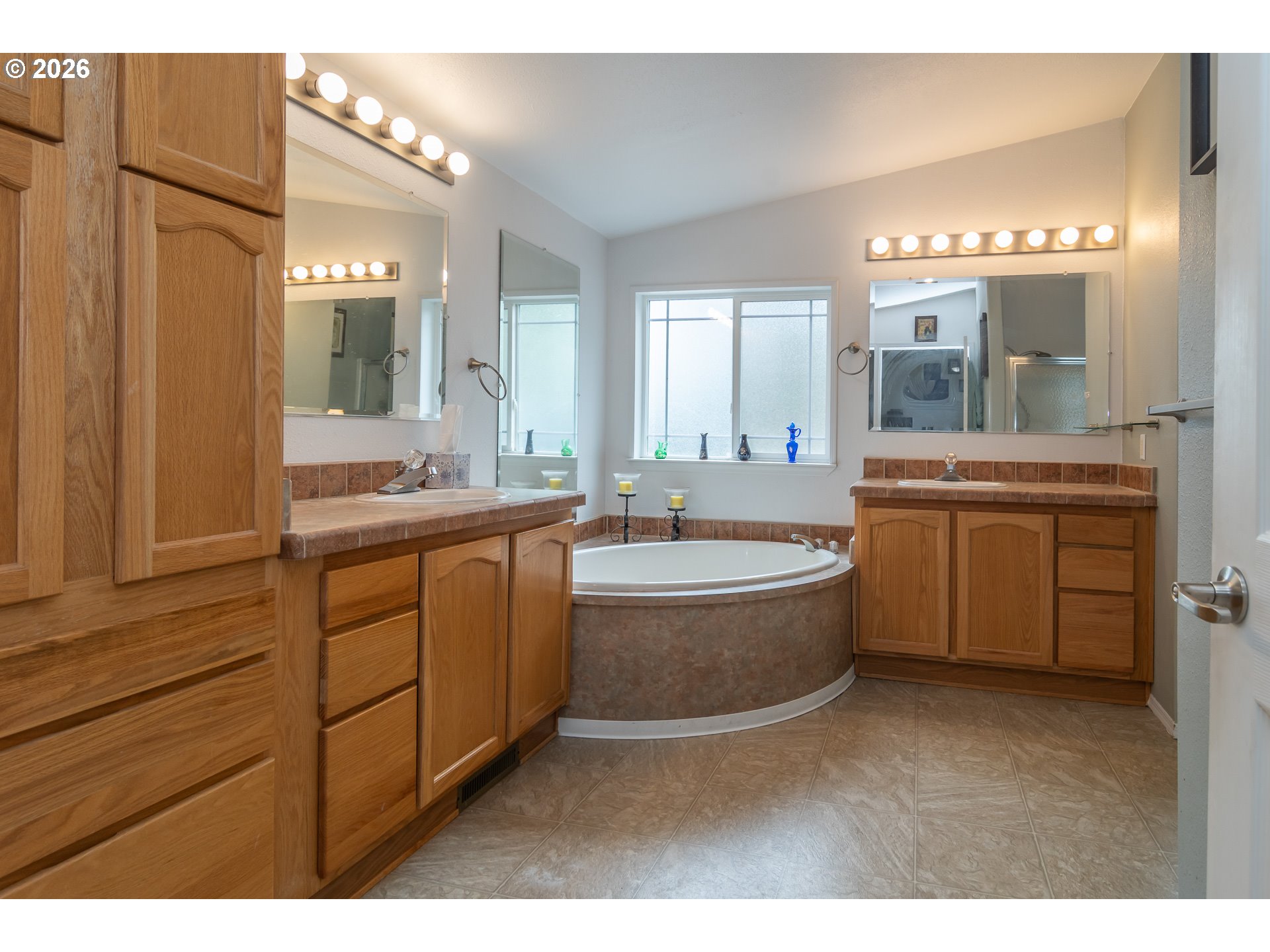562 Valley Road Roseburg, OR 97471 - Photo 23 of 48 a bathroom with a granite countertop sink mirror and a bathtub