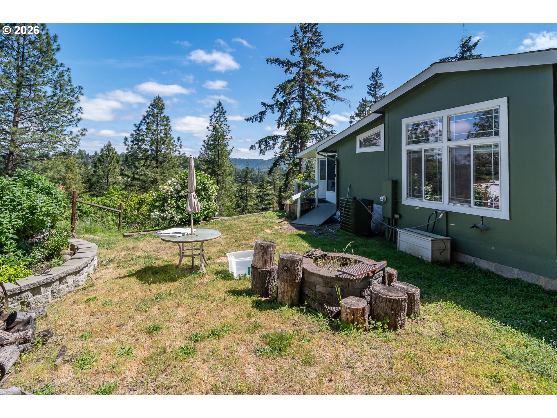 562 Valley Road Roseburg, OR 97471 - Photo 35 of 48 a backyard of a house with table and chairs
