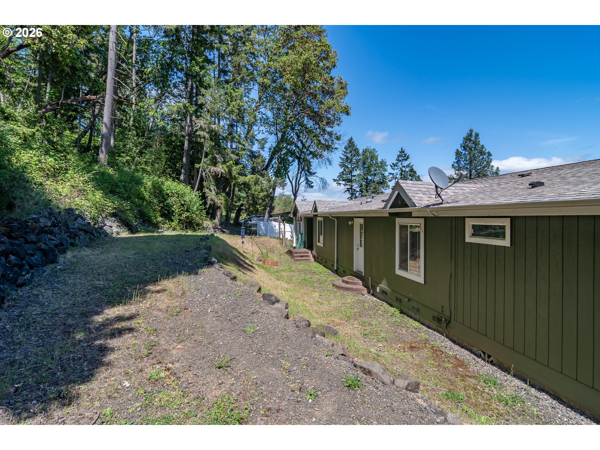 562 Valley Road Roseburg, OR 97471 - Photo 36 of 48 a view of a backyard with a large tree