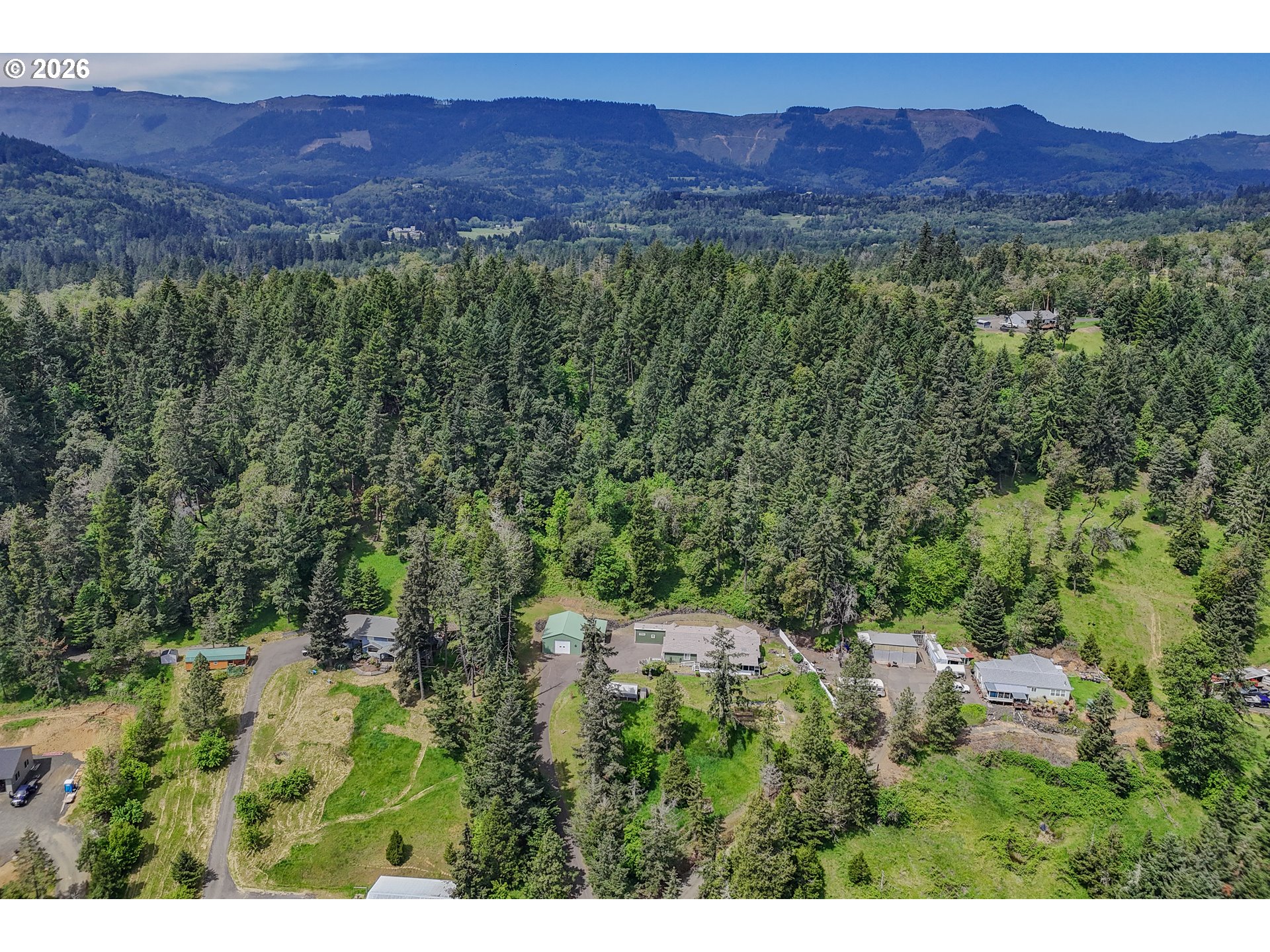 562 Valley Road Roseburg, OR 97471 - Photo 45 of 48 a view of a lush green hillside and a building