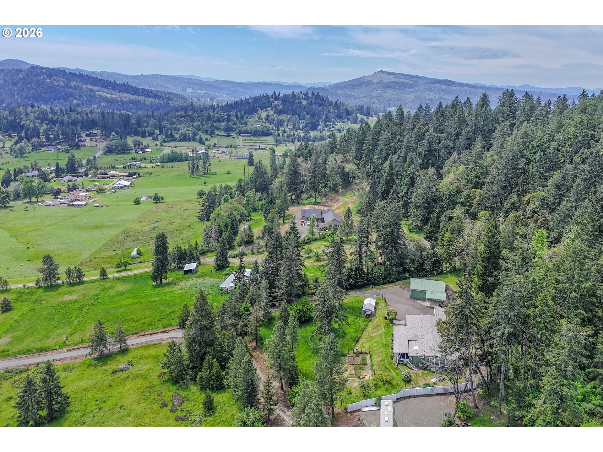 562 Valley Road Roseburg, OR 97471 - Photo 46 of 48 a view of a lush green field with houses in the background