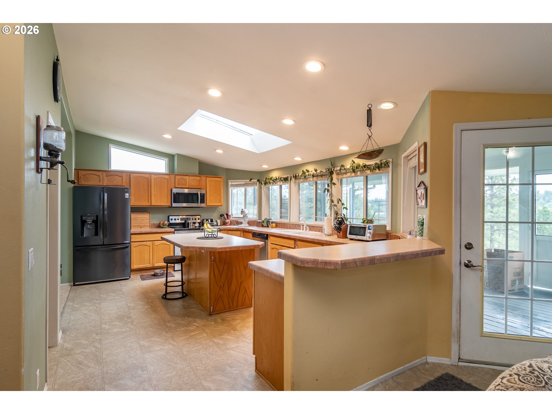 562 Valley Road Roseburg, OR 97471 - Photo 9 of 48 a kitchen with kitchen island a sink appliances and cabinets