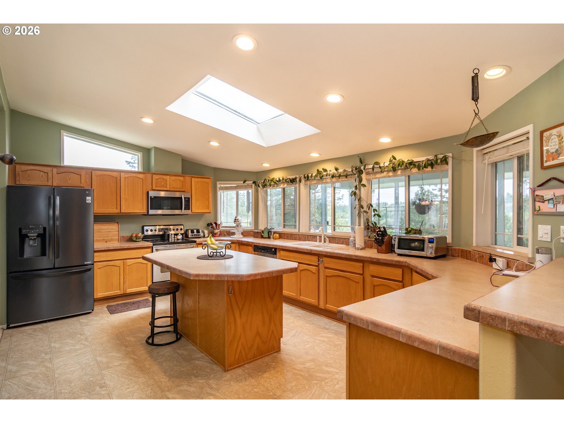 562 Valley Road Roseburg, OR 97471 - Photo 10 of 48 a kitchen with stainless steel appliances kitchen island granite countertop a sink and stove