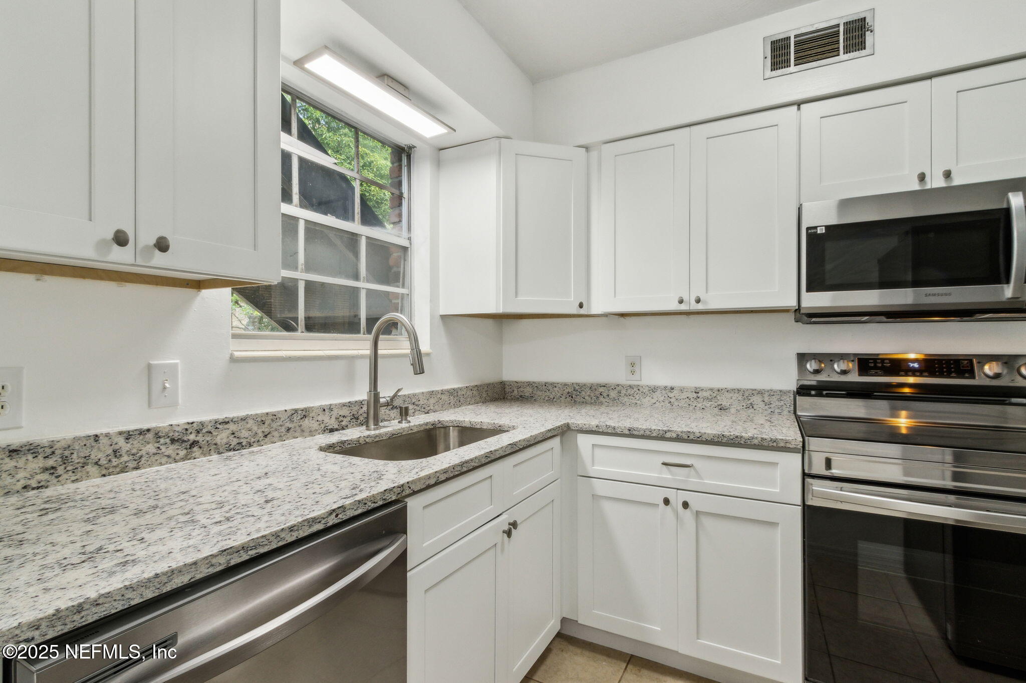 1846 Mallory Street, Unit 8 Jacksonville, FL 32205 - Photo 14 of 25 a kitchen with granite countertop a sink and a stove