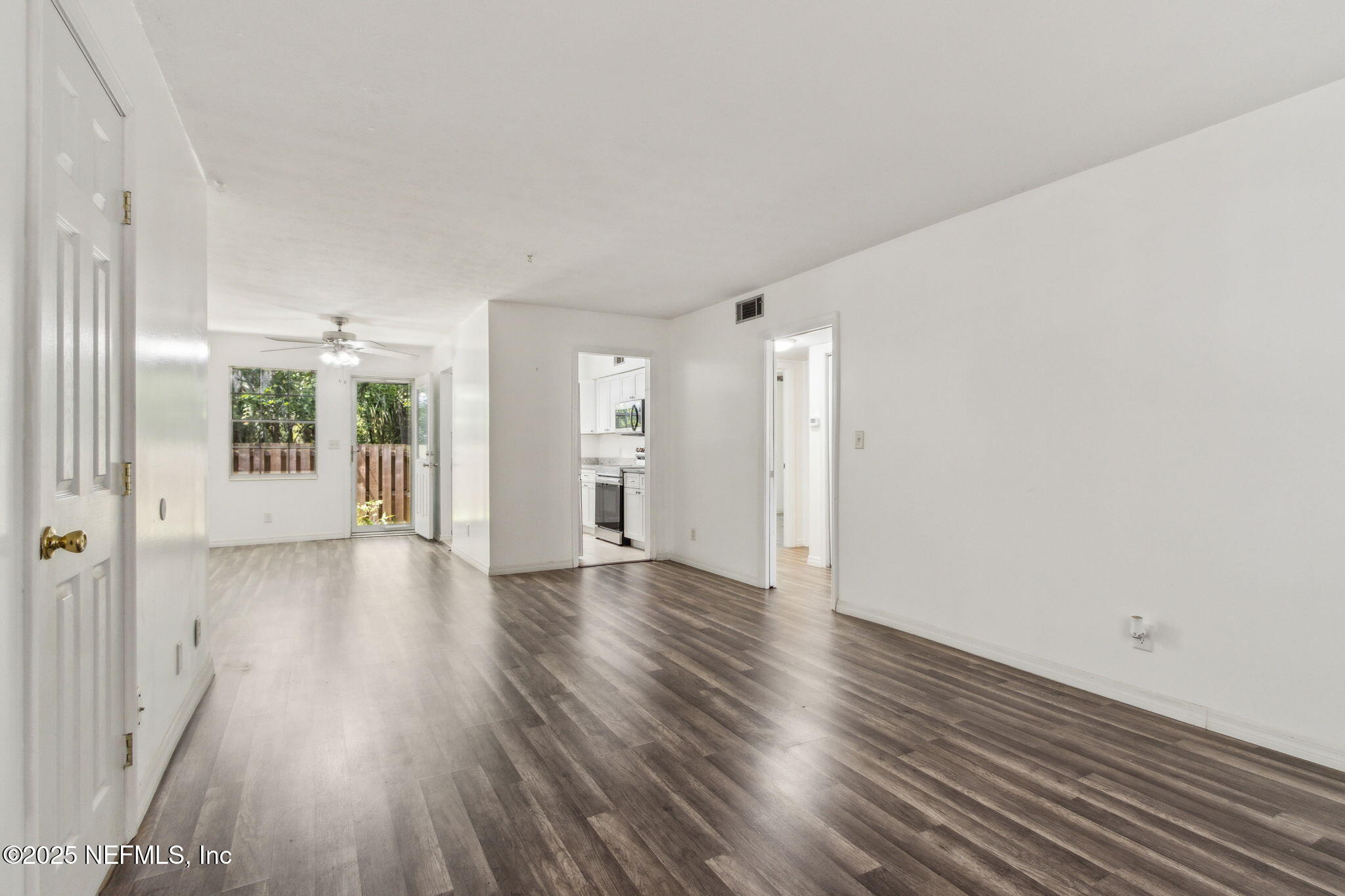 1846 Mallory Street, Unit 8 Jacksonville, FL 32205 - Photo 7 of 25 a view of an empty room with wooden floor and a window