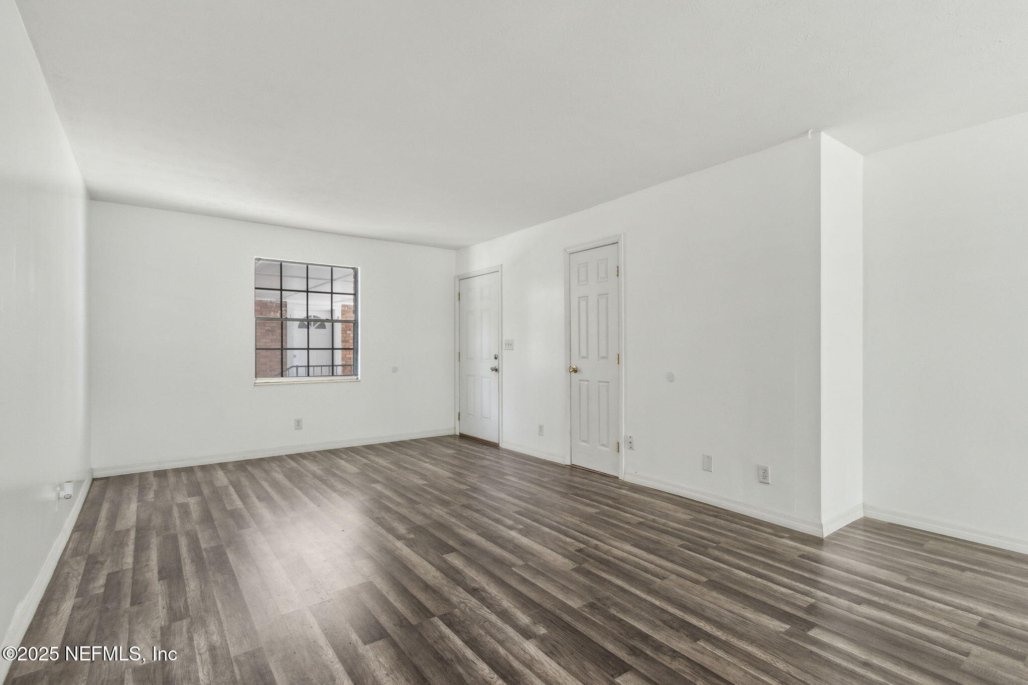 1846 Mallory Street, Unit 8 Jacksonville, FL 32205 - Photo 8 of 25 a view of an empty room with wooden floor and a window