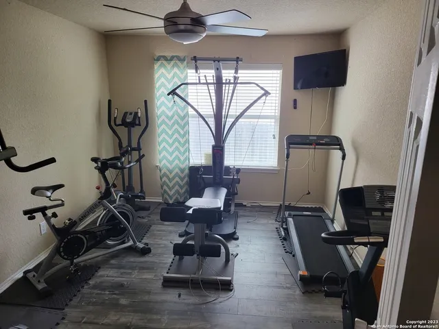 a view of workspace with wooden floor windows