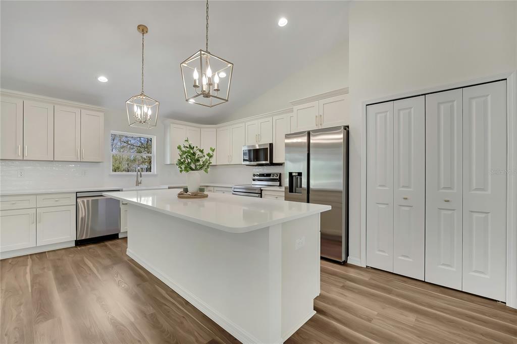 11929 West Cornflower Drive Crystal River, FL 34428 - Photo 12 of 50 a kitchen with stainless steel appliances granite countertop a sink stove and refrigerator