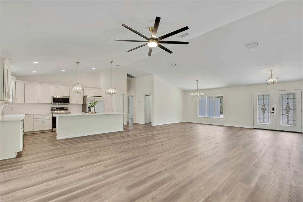 11929 West Cornflower Drive Crystal River, FL 34428 - Photo 13 of 50 a view of kitchen with cabinets wooden floor and a ceiling fan