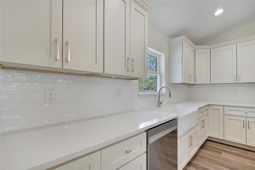 11929 West Cornflower Drive Crystal River, FL 34428 - Photo 17 of 50 a kitchen with white cabinets and white appliances