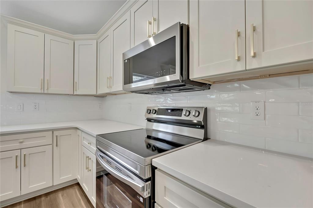 11929 West Cornflower Drive Crystal River, FL 34428 - Photo 19 of 50 a kitchen with a stove and a microwave