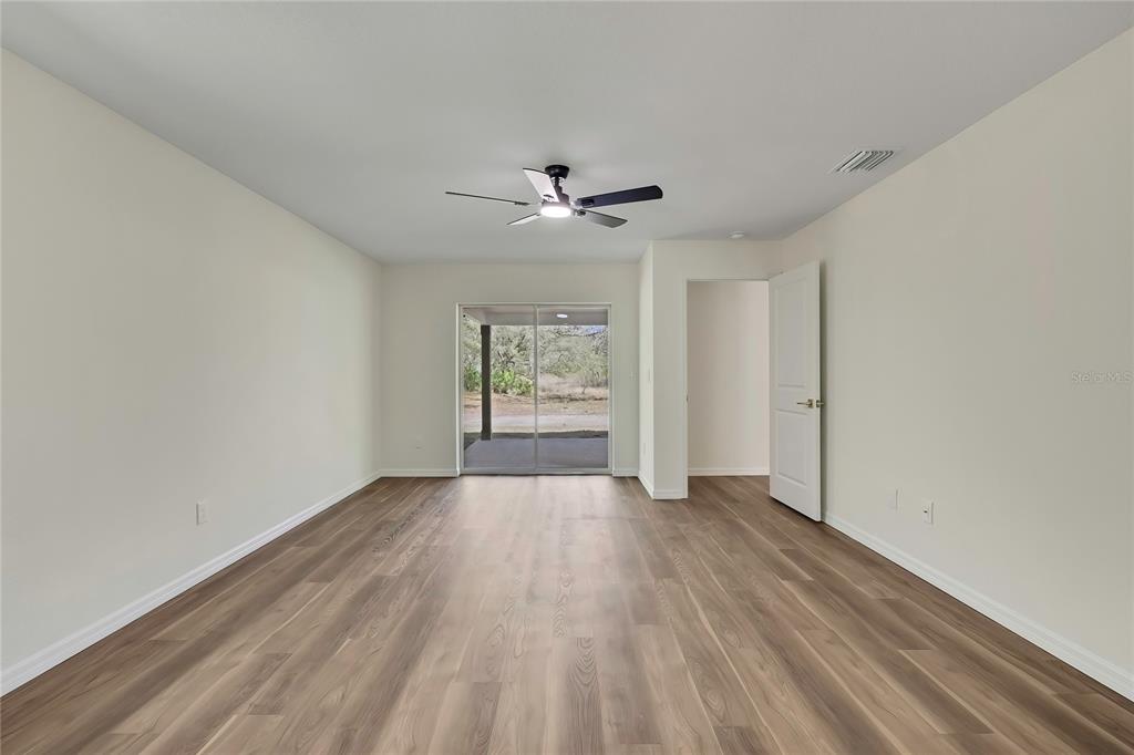 11929 West Cornflower Drive Crystal River, FL 34428 - Photo 23 of 50 wooden floor in an empty room with a window
