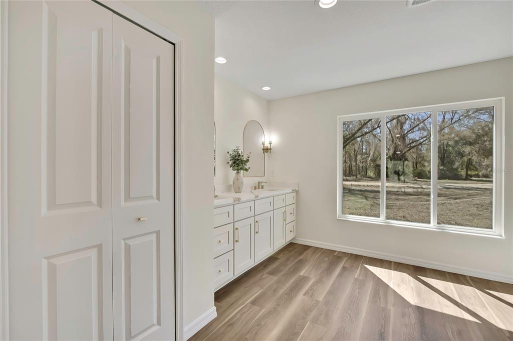 11929 West Cornflower Drive Crystal River, FL 34428 - Photo 25 of 50 a bathroom with a sink and a large mirror