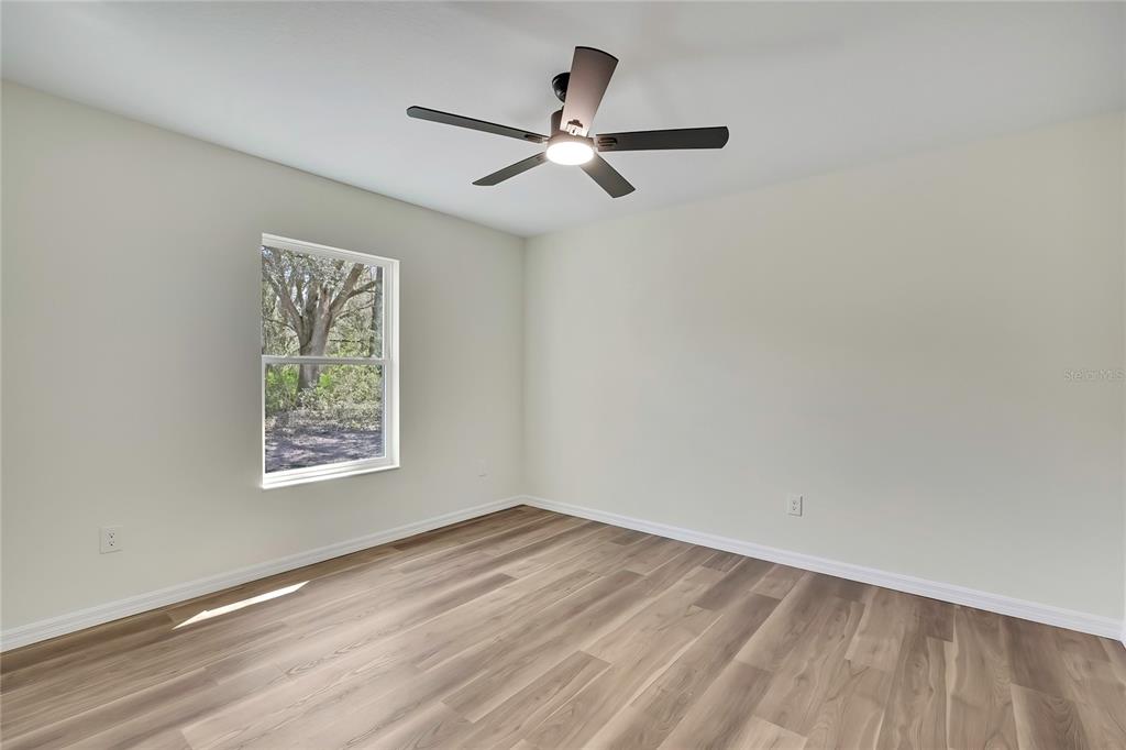 11929 West Cornflower Drive Crystal River, FL 34428 - Photo 27 of 50 wooden floor in an empty room with a window