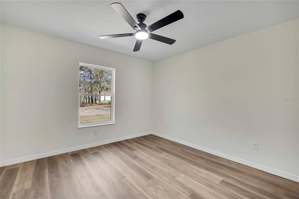 11929 West Cornflower Drive Crystal River, FL 34428 - Photo 32 of 50 an empty room with a window and a fan