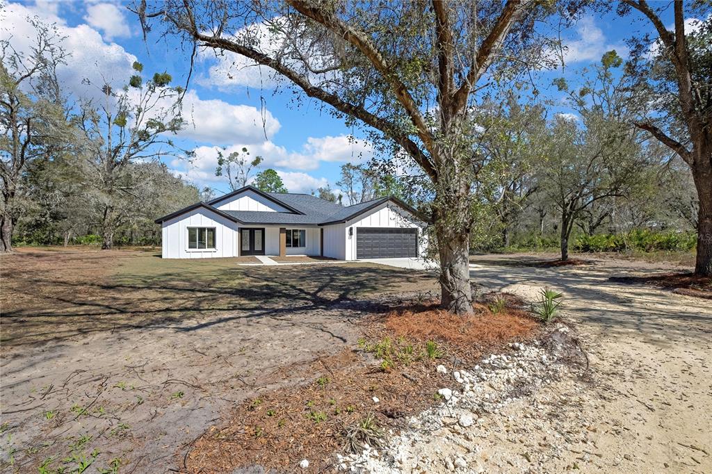 11929 West Cornflower Drive Crystal River, FL 34428 - Photo 43 of 50 a front view of a house with a yard