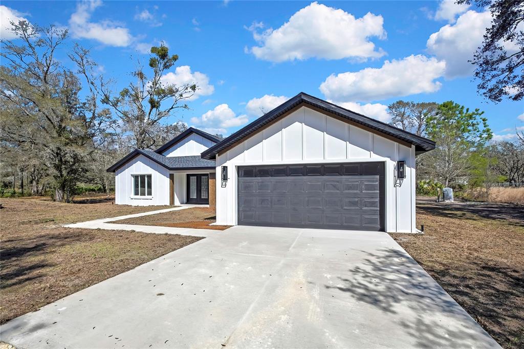 11929 West Cornflower Drive Crystal River, FL 34428 - Photo 7 of 50 a front view of a house with a yard and garage
