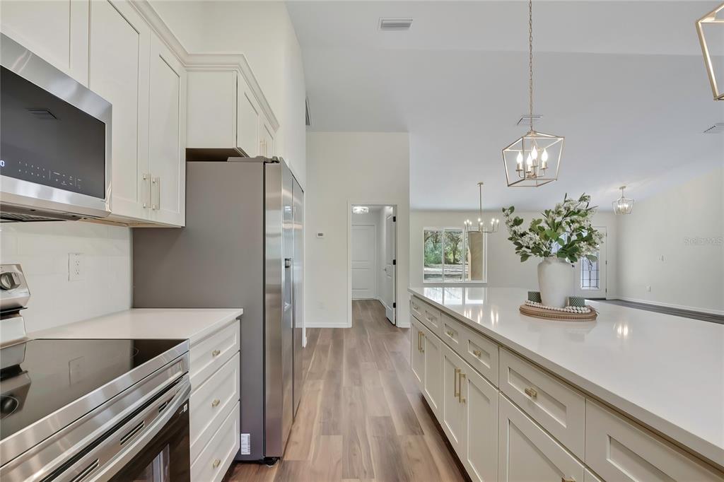 11929 West Cornflower Drive Crystal River, FL 34428 - Photo 9 of 50 a kitchen with a large counter top space cabinets and stainless steel appliances