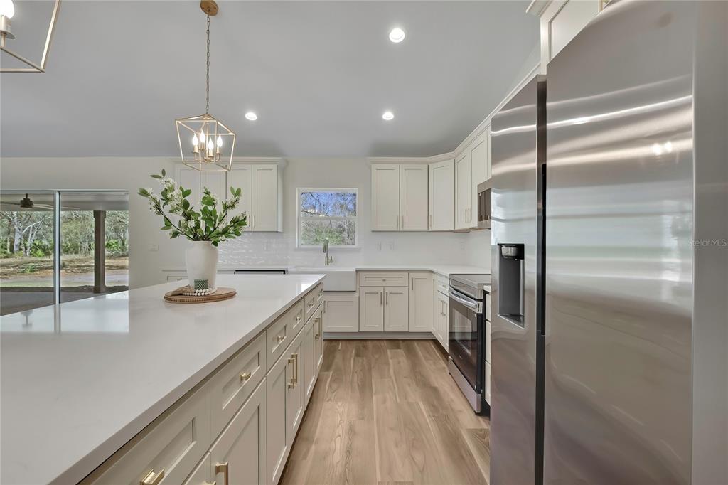 11929 West Cornflower Drive Crystal River, FL 34428 - Photo 10 of 50 a kitchen with a refrigerator and countertop