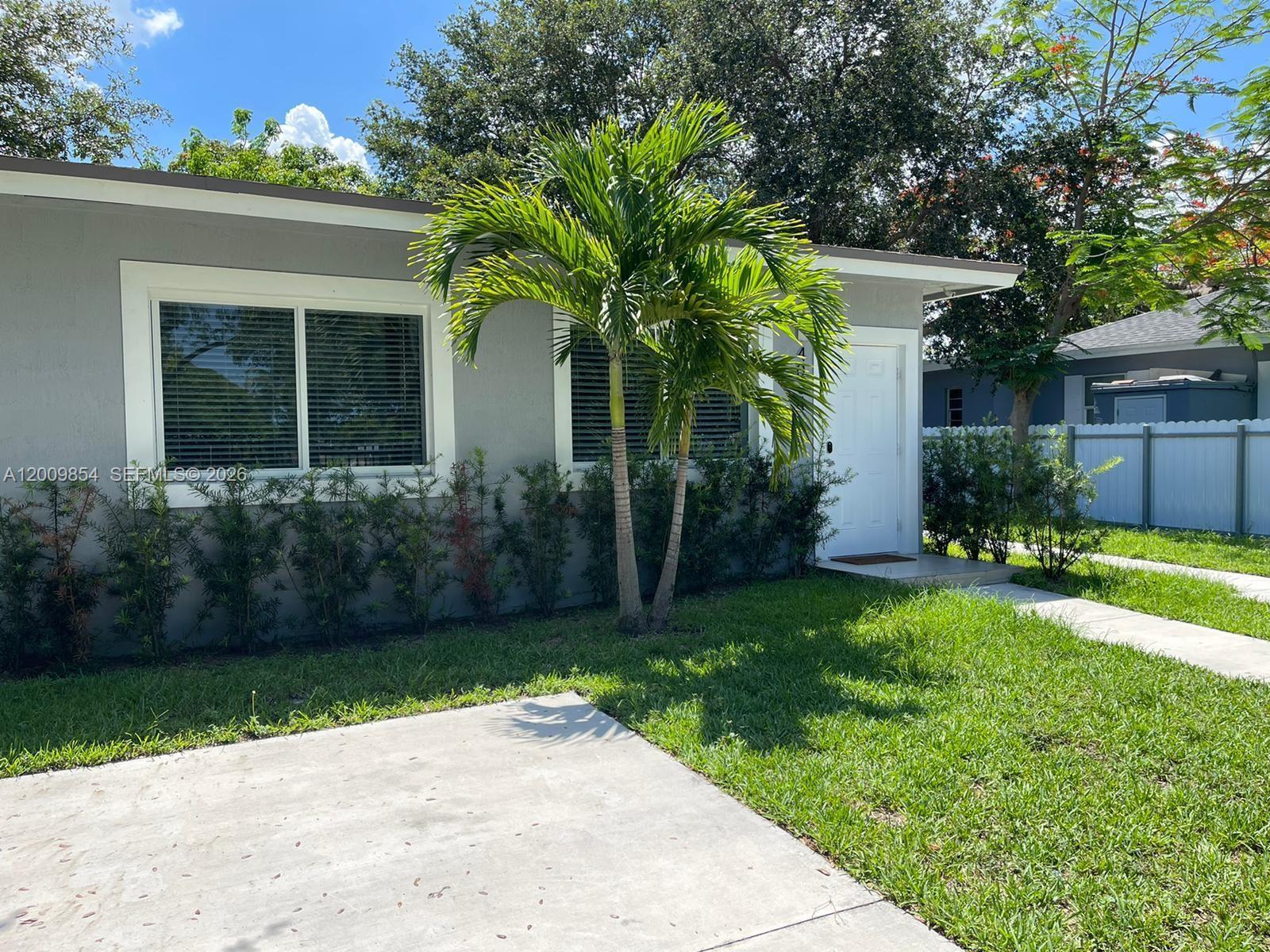 4034 Northwest 23rd Avenue Miami, FL 33142 - Photo 2 of 10 a front view of a house with garden
