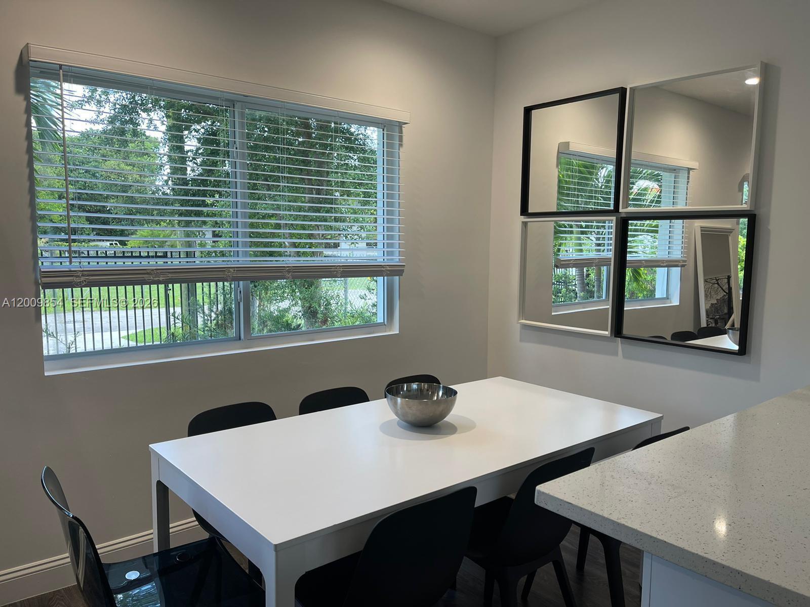 4034 Northwest 23rd Avenue Miami, FL 33142 - Photo 5 of 10 a view of a dining room with a table and chairs