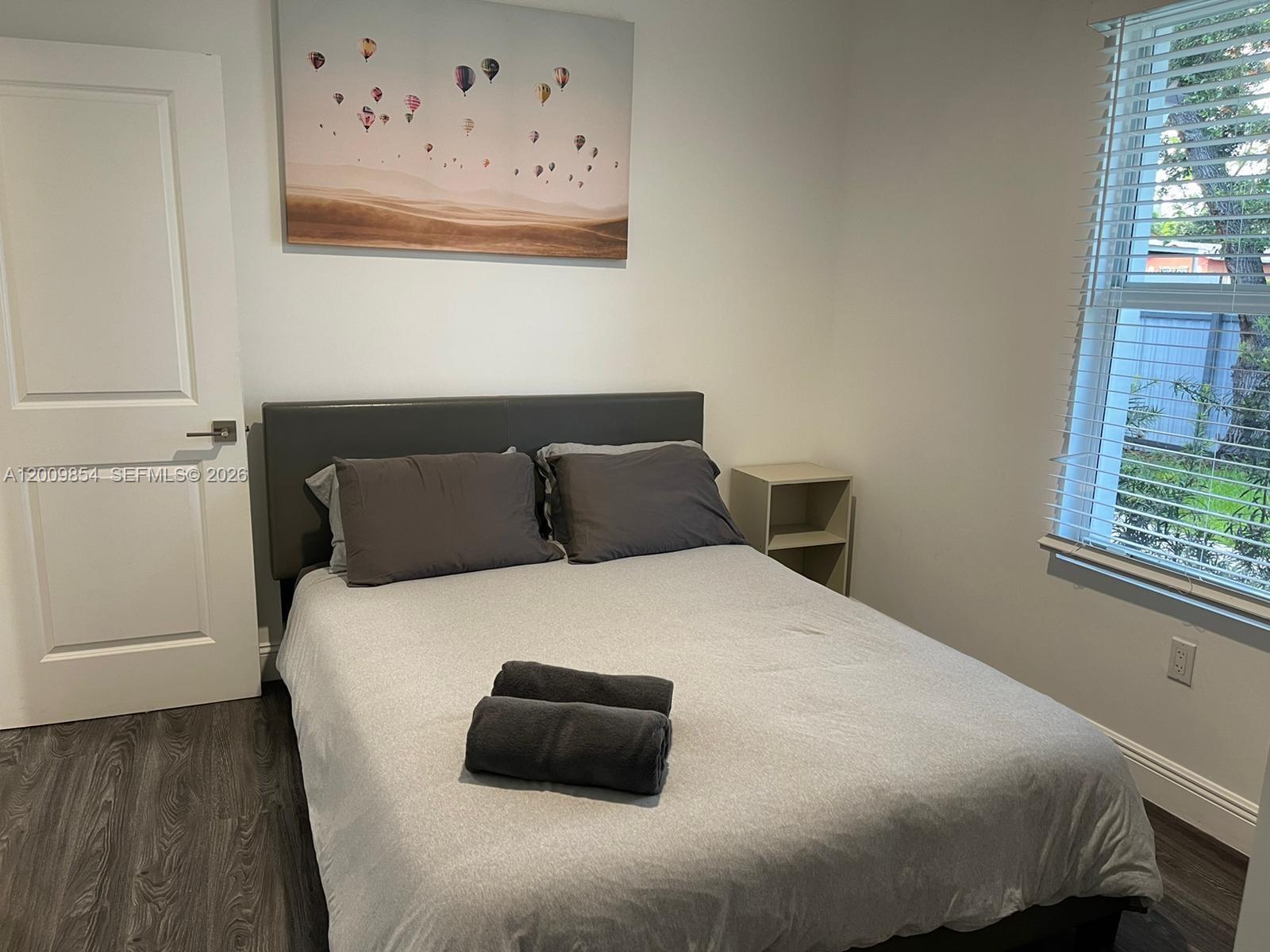 4034 Northwest 23rd Avenue Miami, FL 33142 - Photo 9 of 10 a bedroom with a bed and window