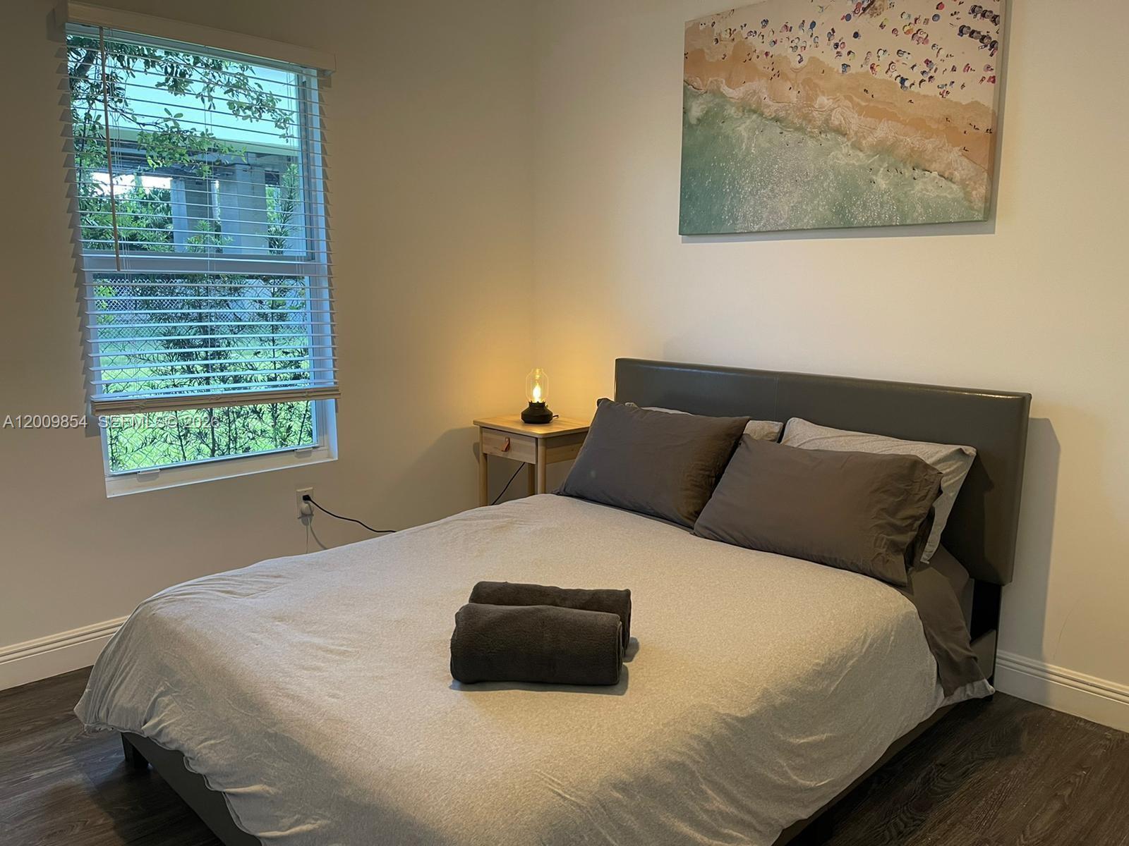 4034 Northwest 23rd Avenue Miami, FL 33142 - Photo 10 of 10 a bedroom with a bed and a window