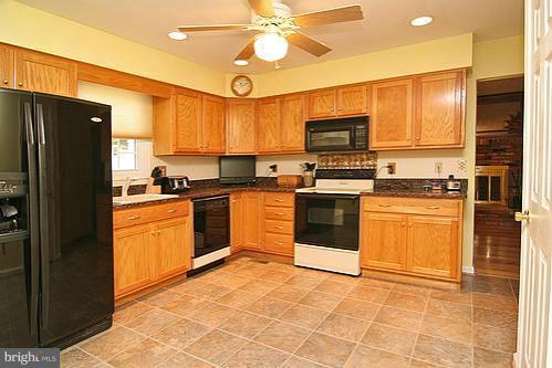 897 Bear Branch Road Westminster, MD 21157 - Photo 3 of 24 a kitchen with a stove a sink and a refrigerator