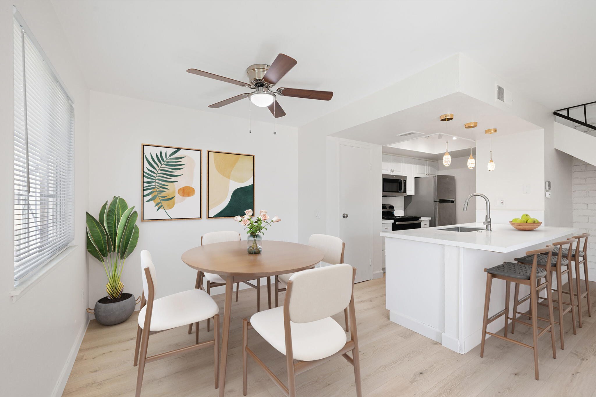 72644 Raven Road, Unit 2 Palm Desert, CA 92260 - Photo 5 of 21 a kitchen with stainless steel appliances kitchen island a table and chairs in it
