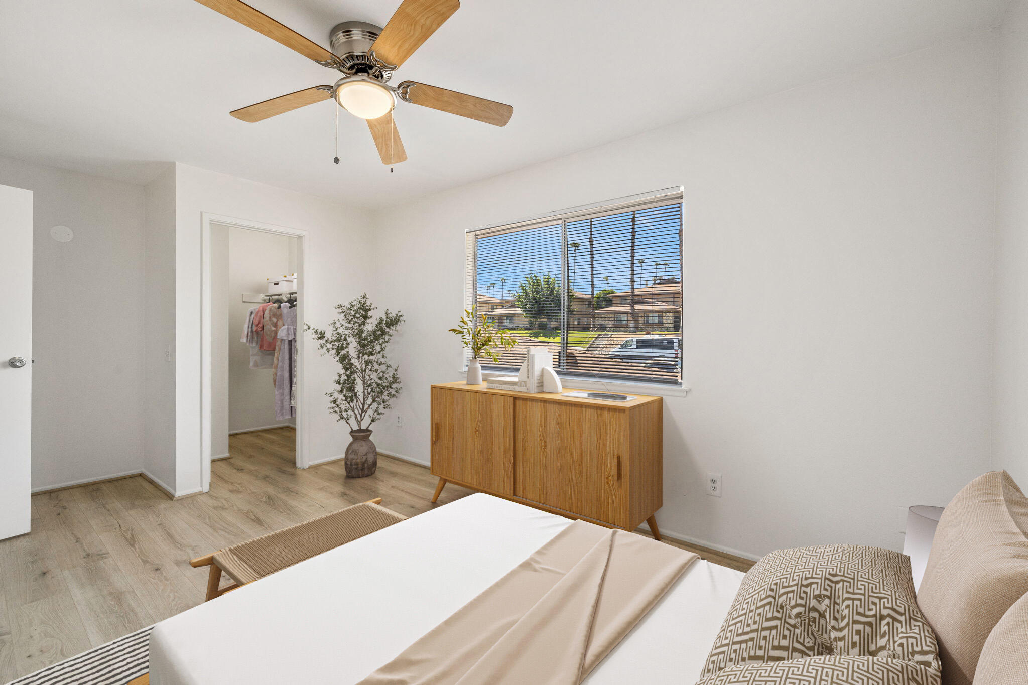 72644 Raven Road, Unit 2 Palm Desert, CA 92260 - Photo 10 of 21 a kitchen with kitchen island a stove a refrigerator a sink a dining table and chairs with wooden floor