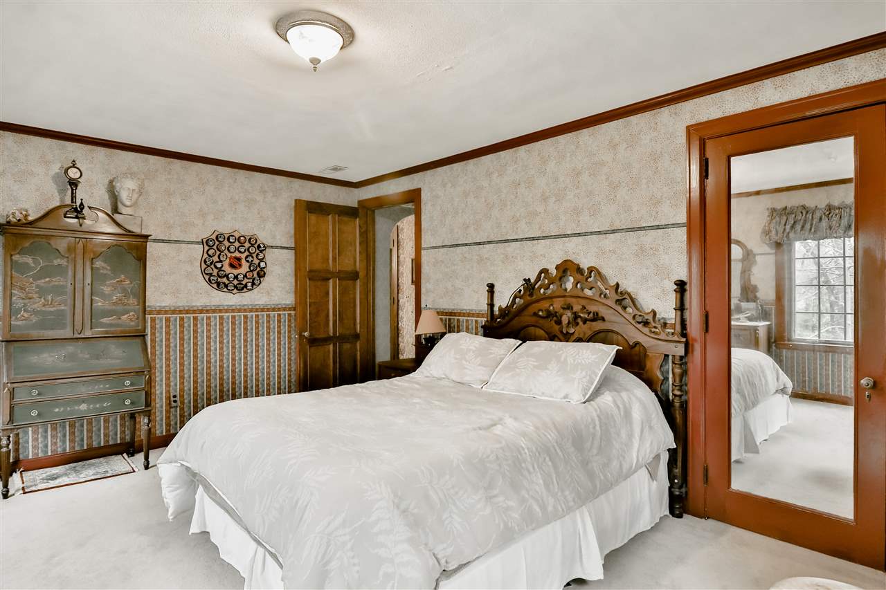 2912 Spring Creek Road Rockford, IL 61107 - Photo 24 of 40 a bedroom with a bed and a painting on the wall