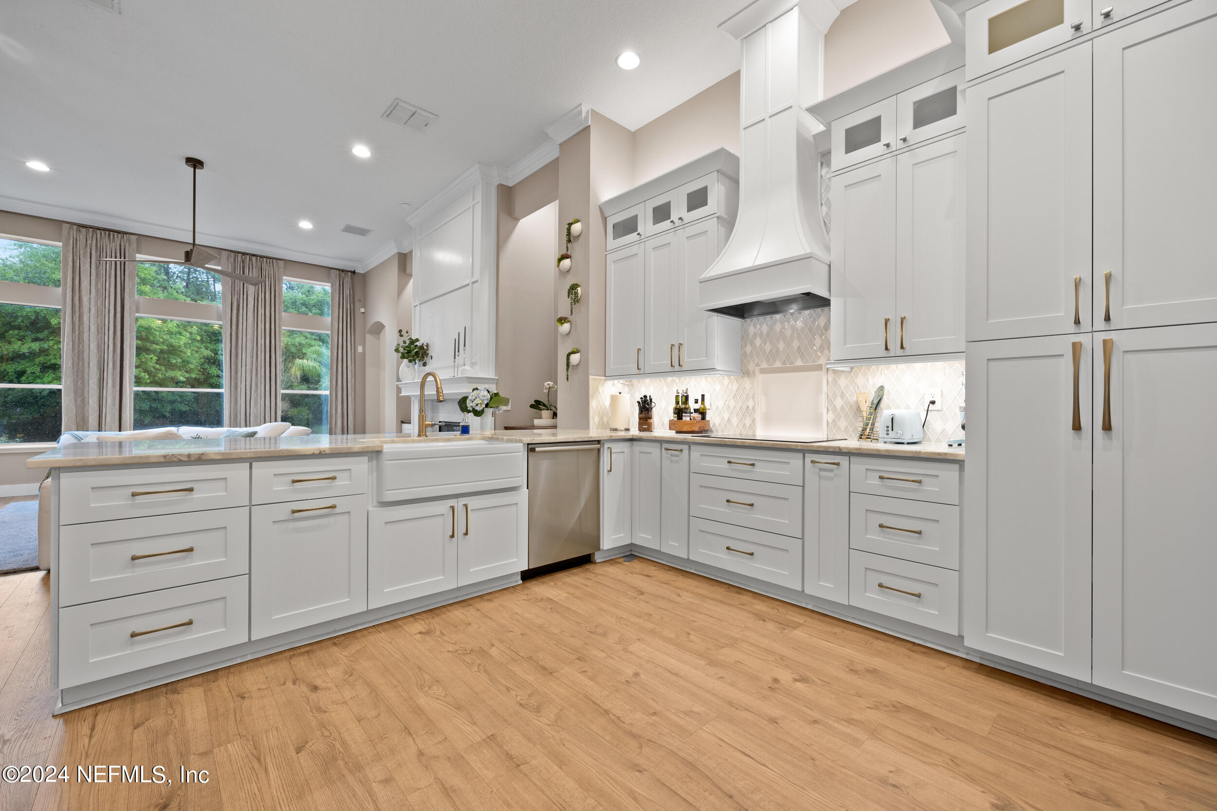 a open kitchen with white cabinets and stainless steel appliances