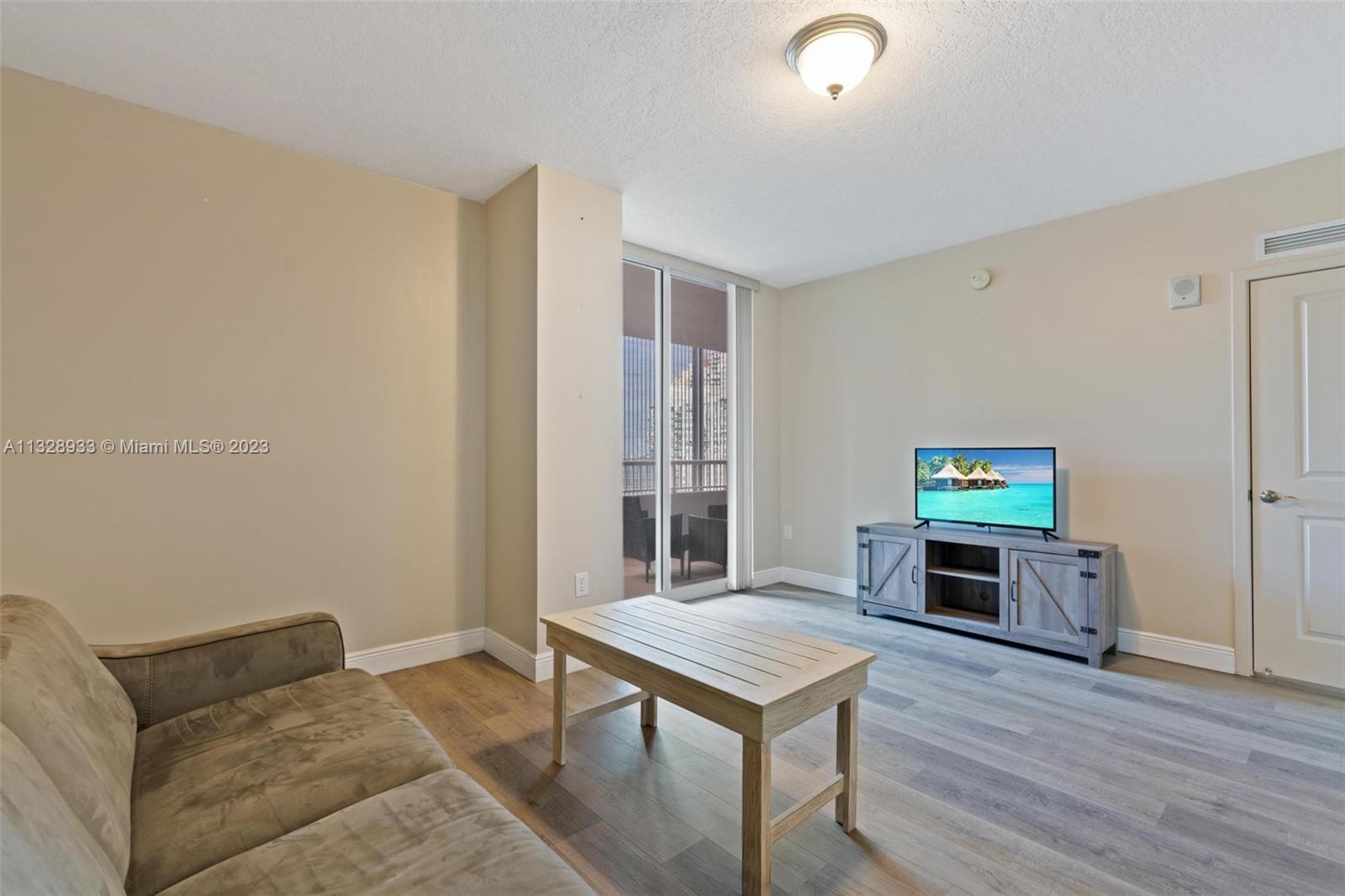 170 Southeast 14th Street, Unit 1906 Miami, FL 33131 - Photo 13 of 26 a living room with furniture and a wooden floor