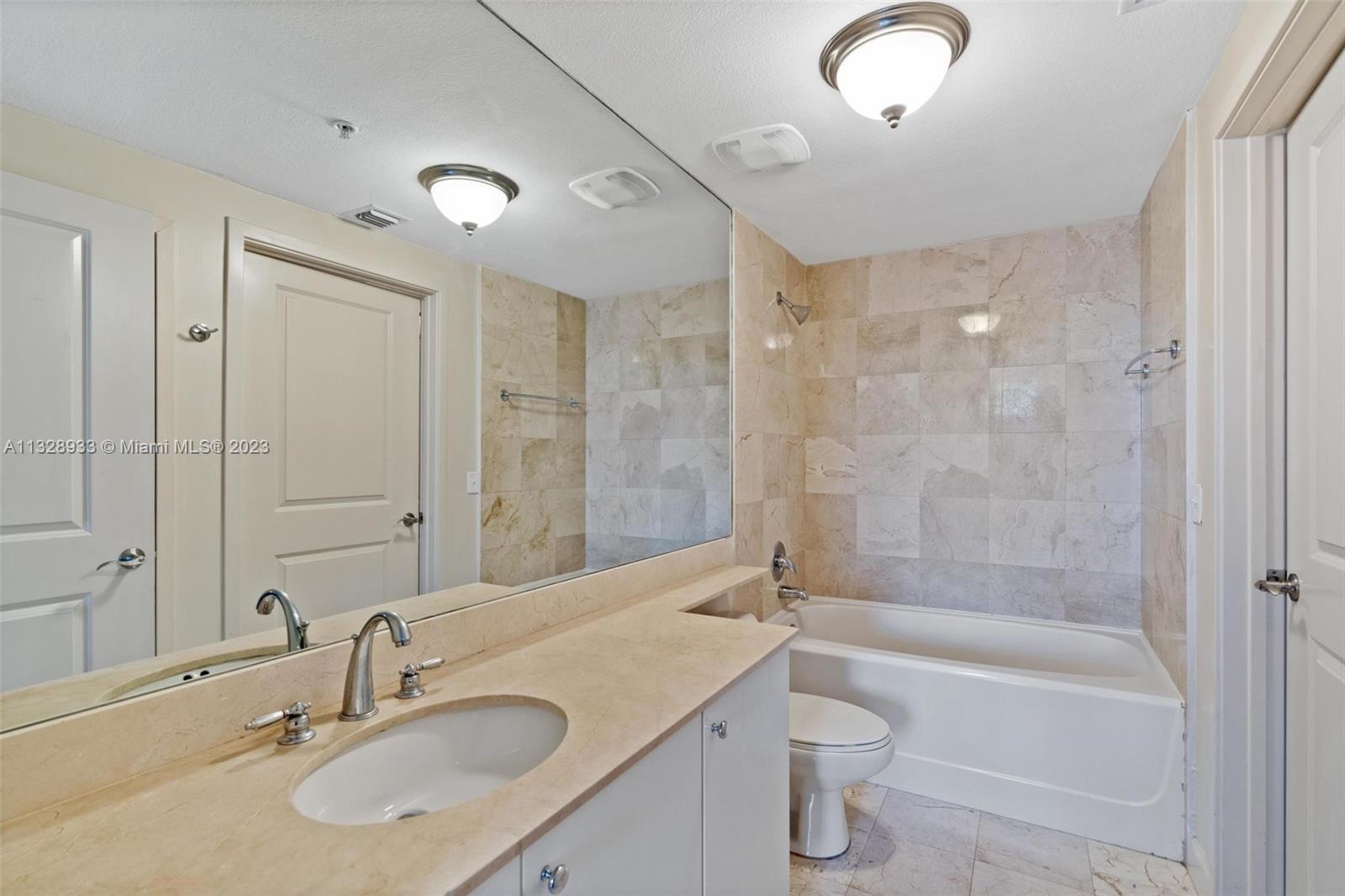 170 Southeast 14th Street, Unit 1906 Miami, FL 33131 - Photo 14 of 26 a bathroom with a sink a toilet and shower