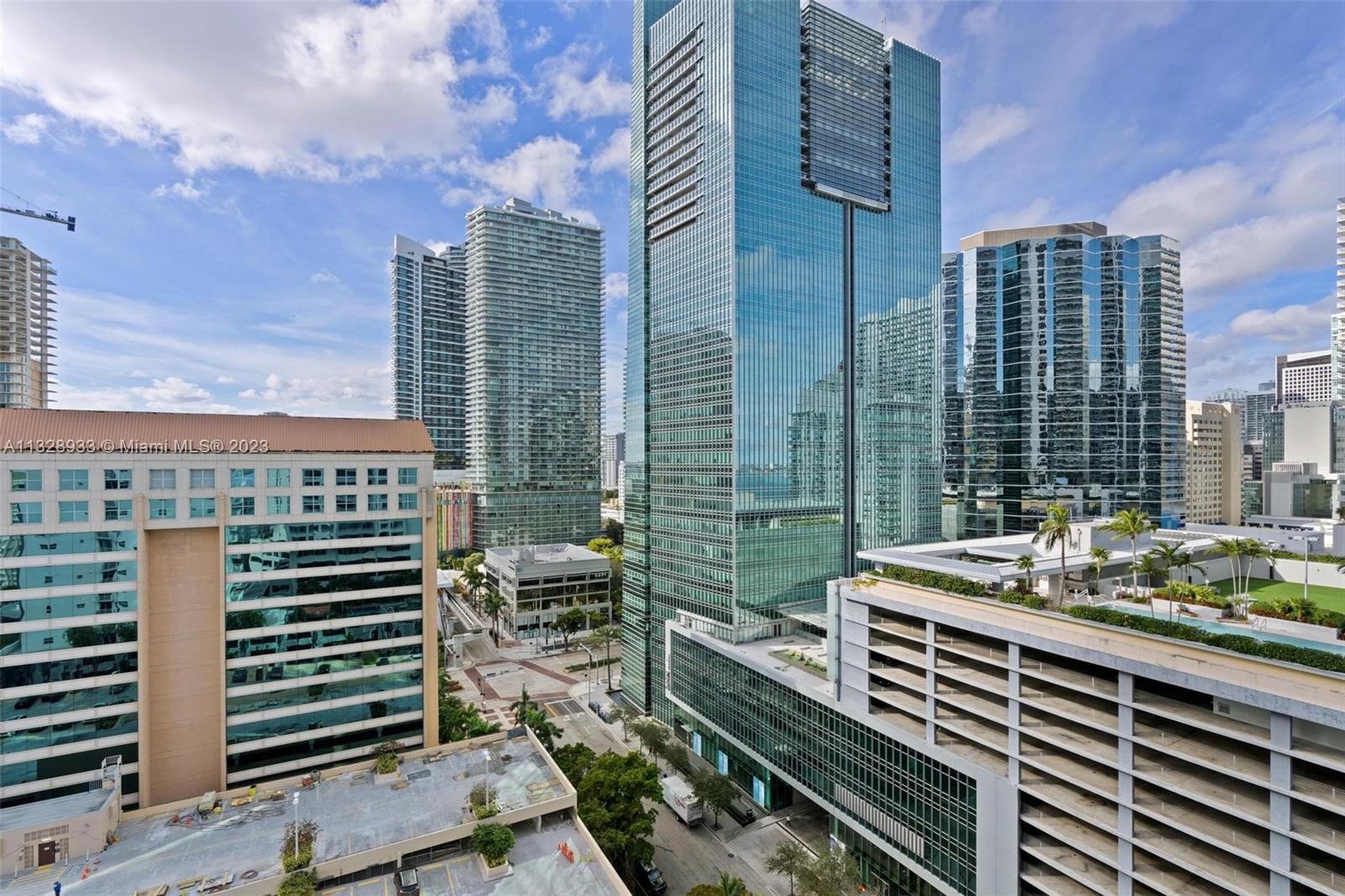 170 Southeast 14th Street, Unit 1906 Miami, FL 33131 - Photo 19 of 26 a view of a balcony with couches and wooden floor