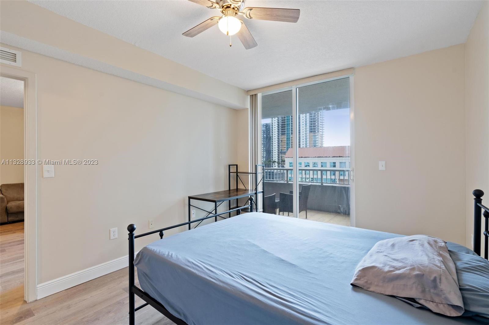170 Southeast 14th Street, Unit 1906 Miami, FL 33131 - Photo 22 of 26 a bedroom with a bed and a table in it