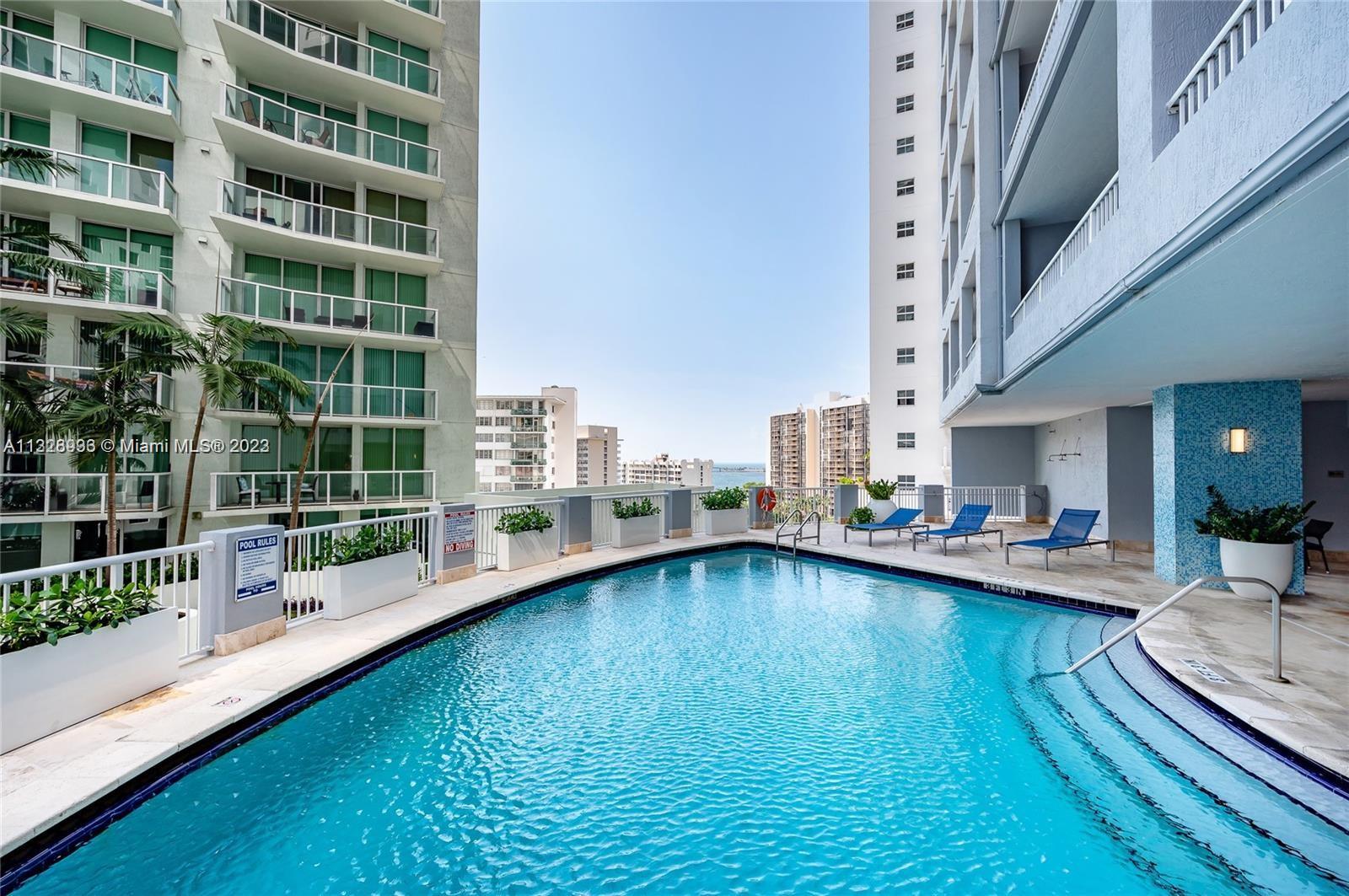 170 Southeast 14th Street, Unit 1906 Miami, FL 33131 - Photo 23 of 26 a view of a living room with furniture and floor to ceiling window