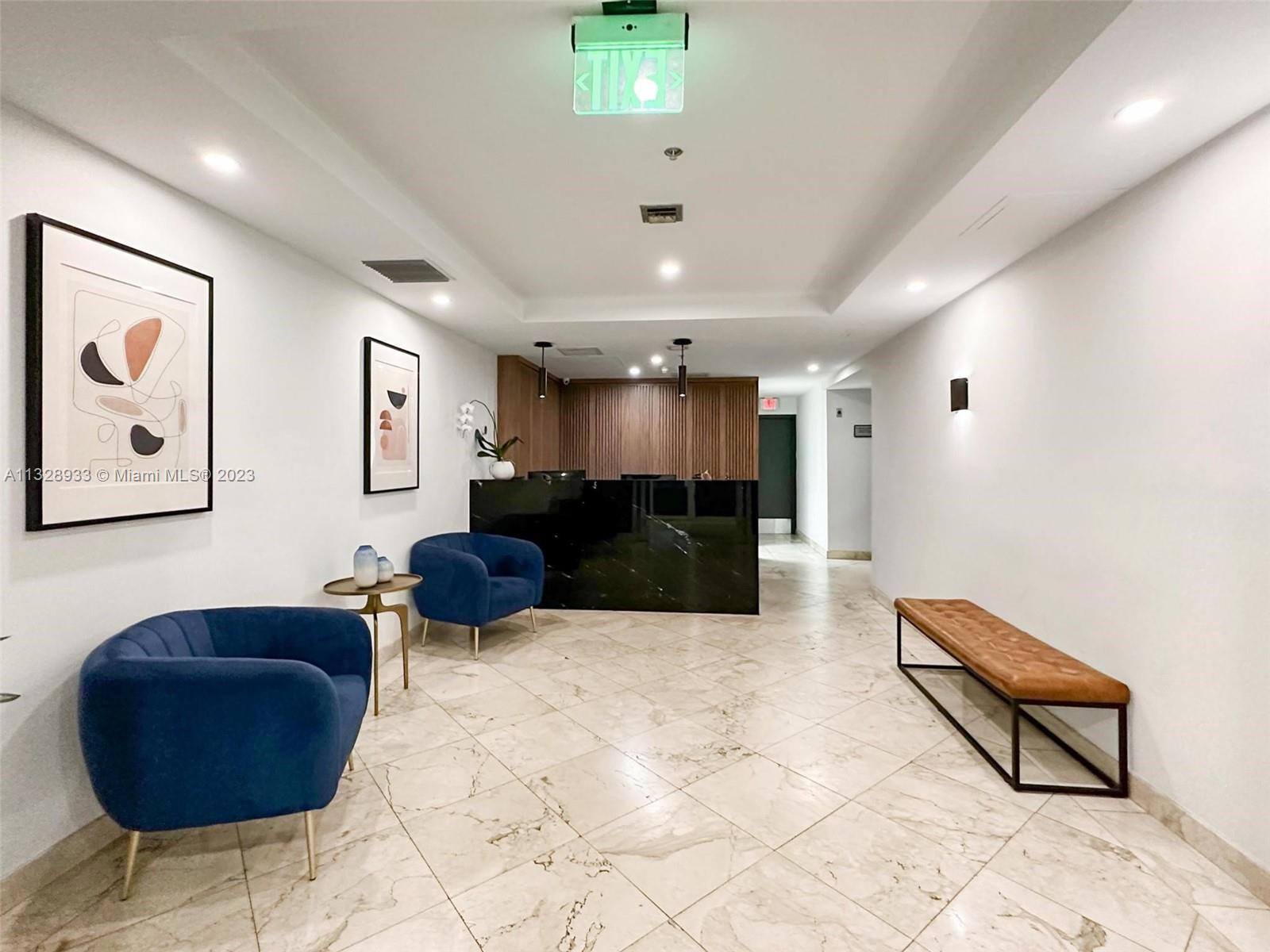 170 Southeast 14th Street, Unit 1906 Miami, FL 33131 - Photo 6 of 26 a lobby with furniture and a rug